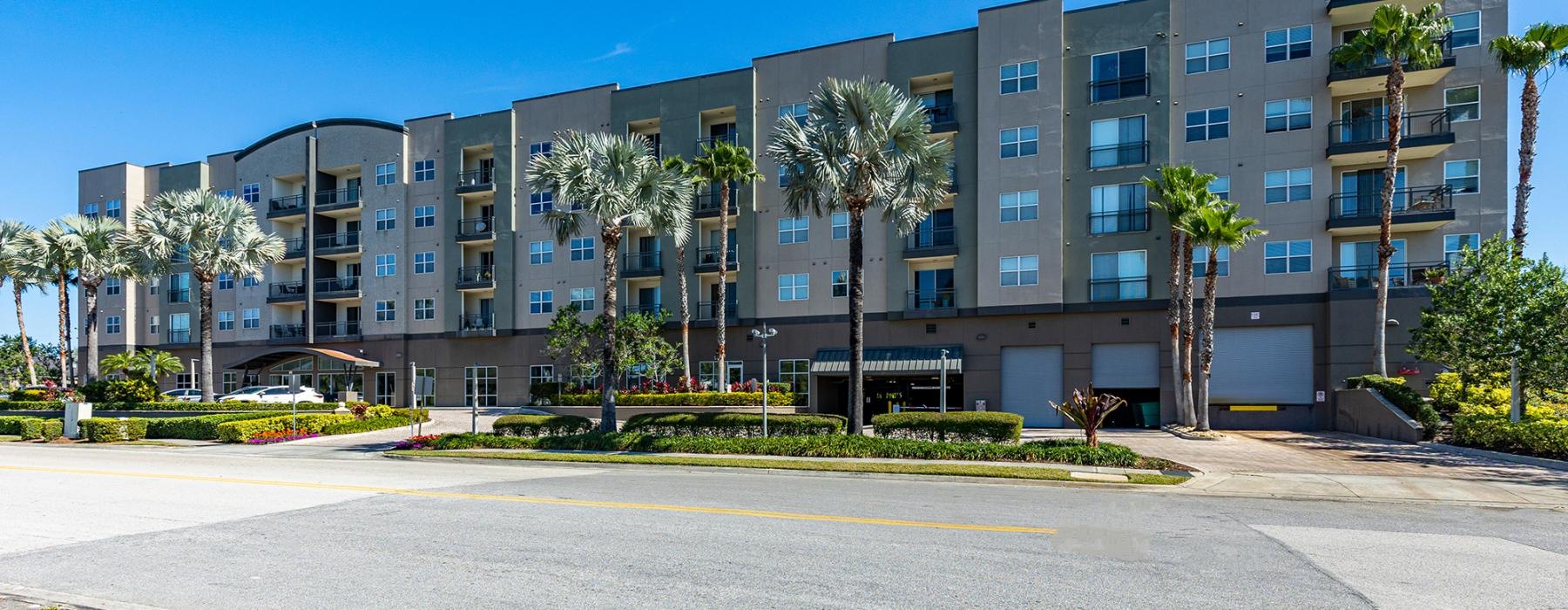 a building with palm trees in front