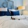 a bed with a bottle of wine on it