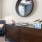 a room with a mirror and a chair