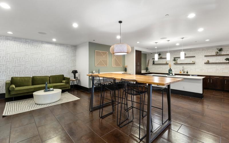 a large kitchen with a large bar and a couch