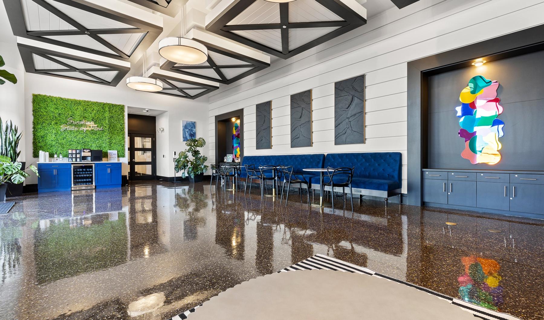 Shimmering resort-style pool a large room with blue chairs and a large pool