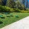 a group of tables in a grassy area next to a building