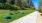 a group of tables in a grassy area next to a building