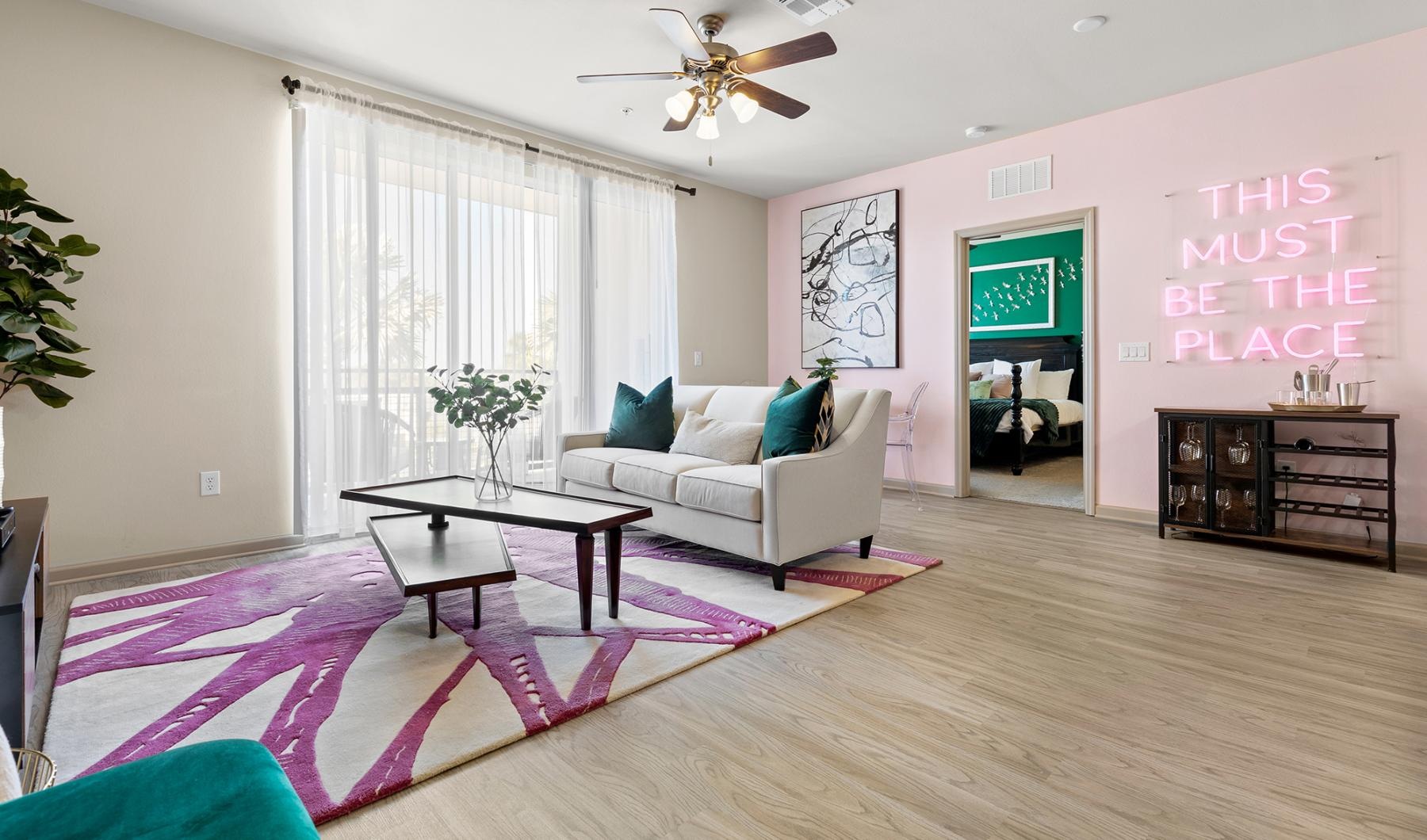 Settle into comfort at Mosaic Westshore a living room with a pink rug