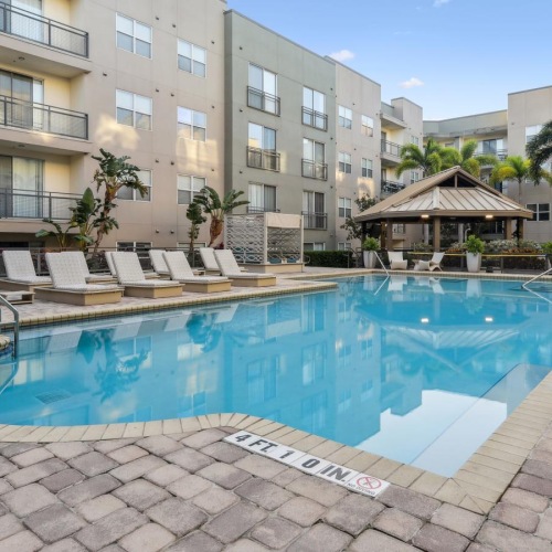 Resort-style swimming pool a swimming pool in front of a building