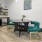 a kitchen with a table chairs and a plant
