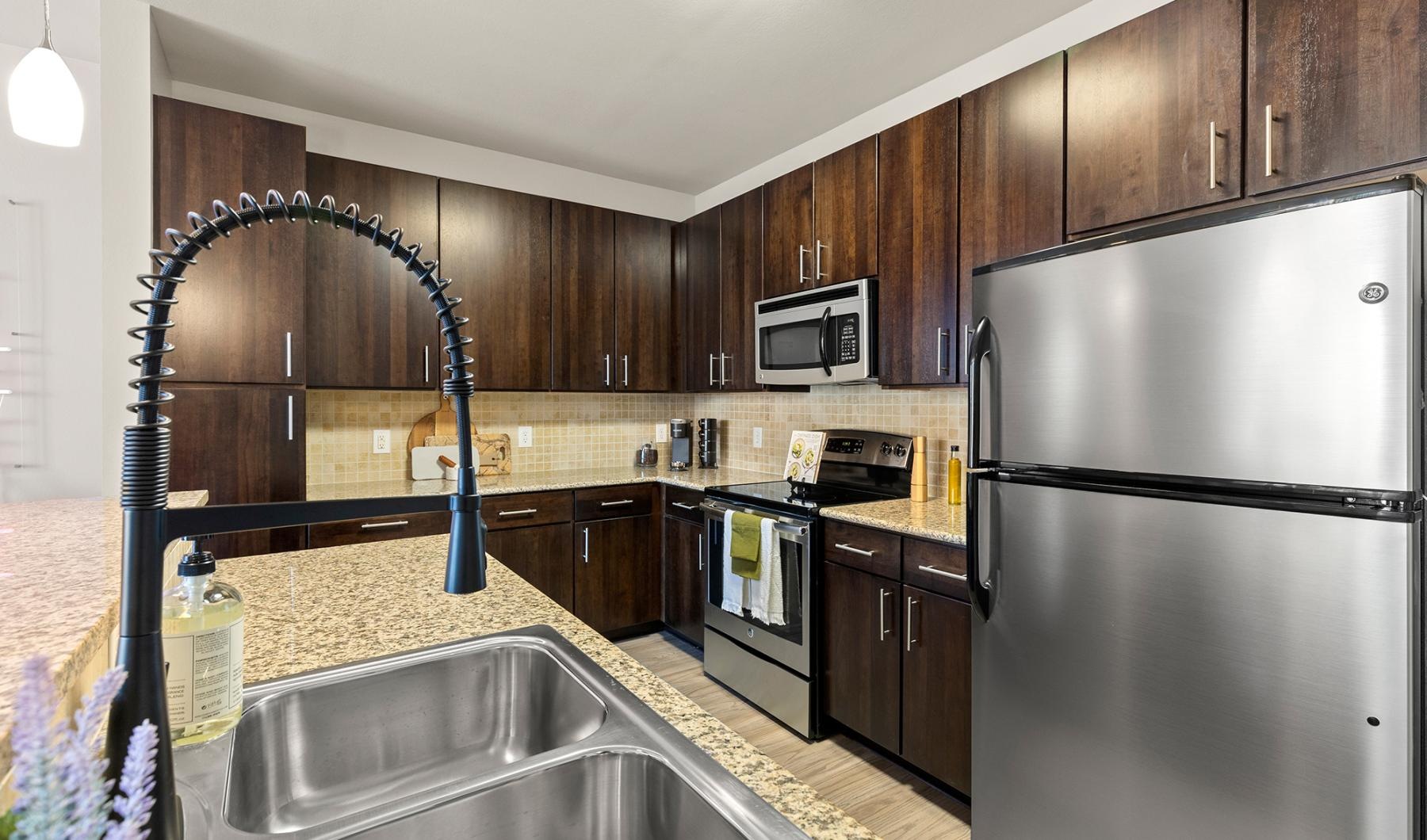 Find your perfect fit at Mosaic Westshore a kitchen with wooden cabinets